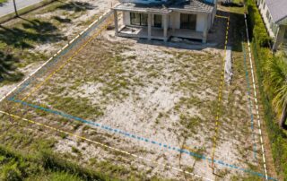 3D rendered scene of a residential lot in St. Johns County, Florida, with a partially built home, marked lot boundaries, palm trees, and neighboring houses under a clear sky.